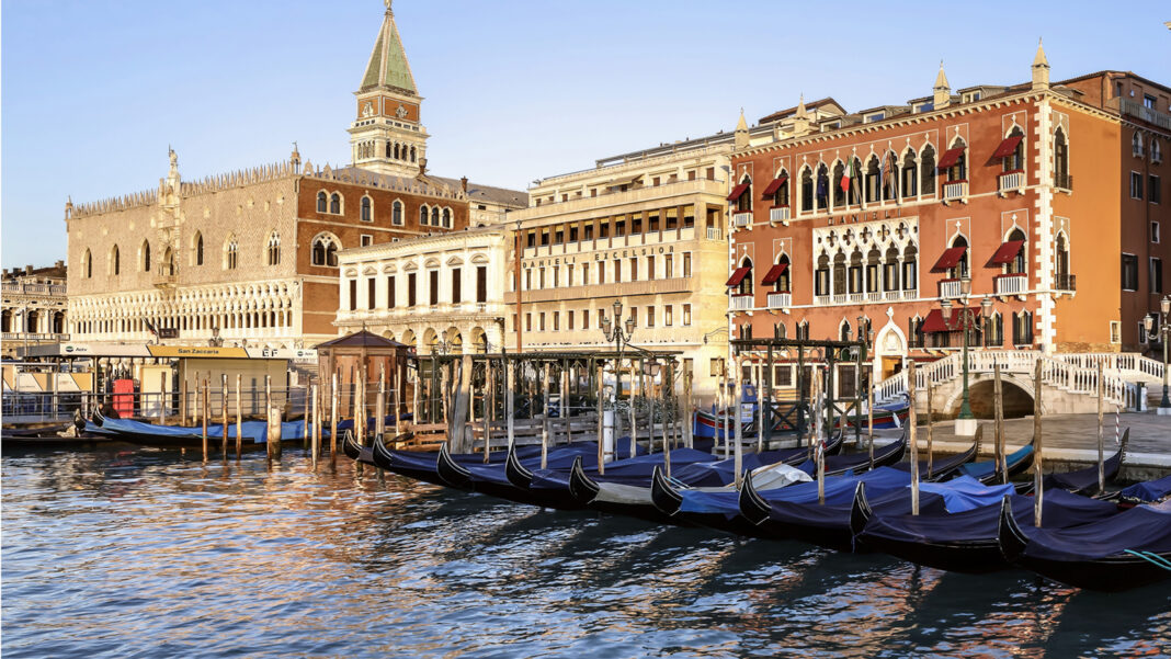 The 10 Most Anticipated Hotel Openings of Late 2026 Terracotta facade of Hotel Danieli on Venice's Riva degli Schiavoni with gondolas moored in front, near the Doge's Palace — reopening as Danieli, a Four Seasons Hotel, on August 26, 2026