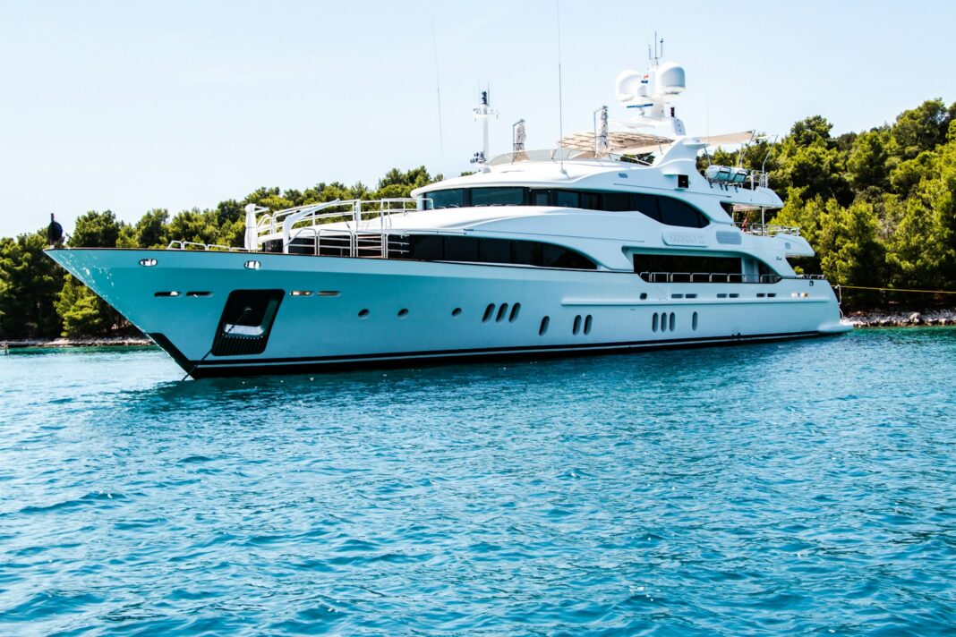 Superyacht at anchor in a Mediterranean bay — luxury yacht charter comparison