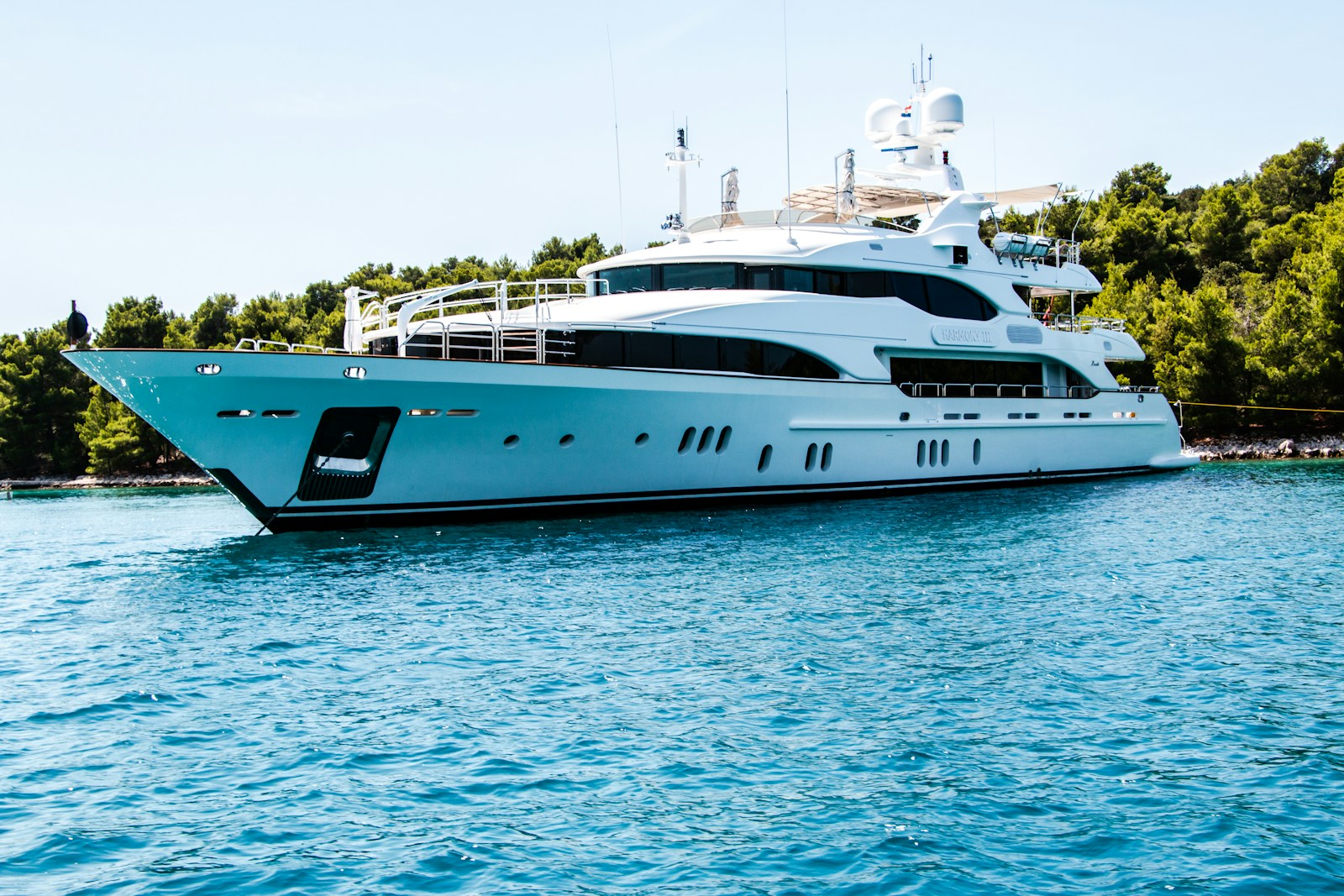 Superyacht at anchor in a Mediterranean bay — luxury yacht charter comparison