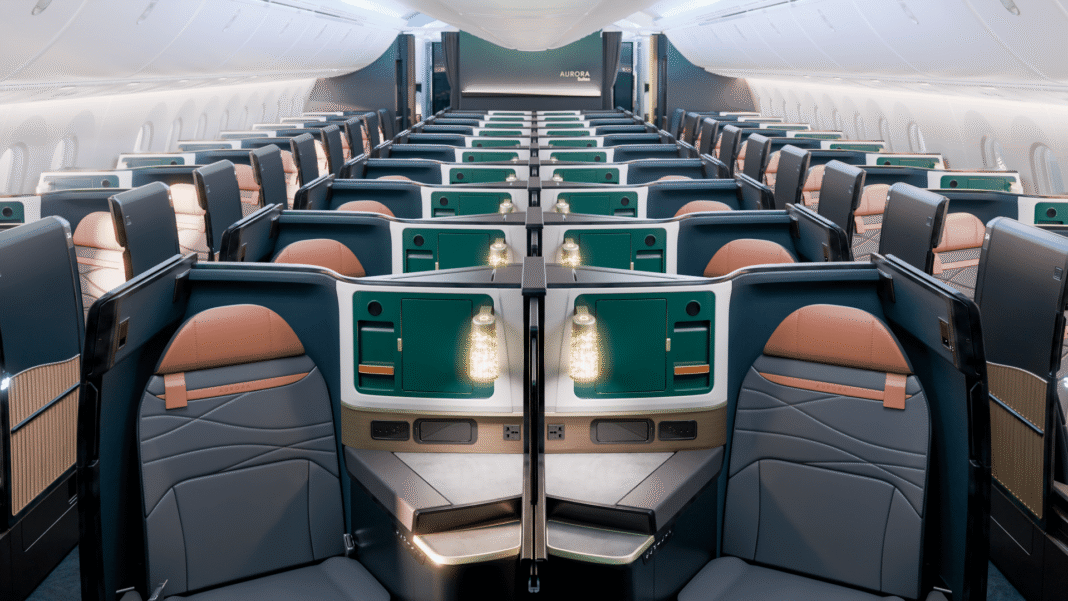 Alaska Aurora and Hawaiian Leihōkū: Inside the New Suites, Premium Reserve and Lounges Rendering of rows of Alaska Airlines Aurora Suites on a Boeing 787-10, with navy suite shells, teal consoles and cognac headrests, and the Aurora name on the forward bulkhead