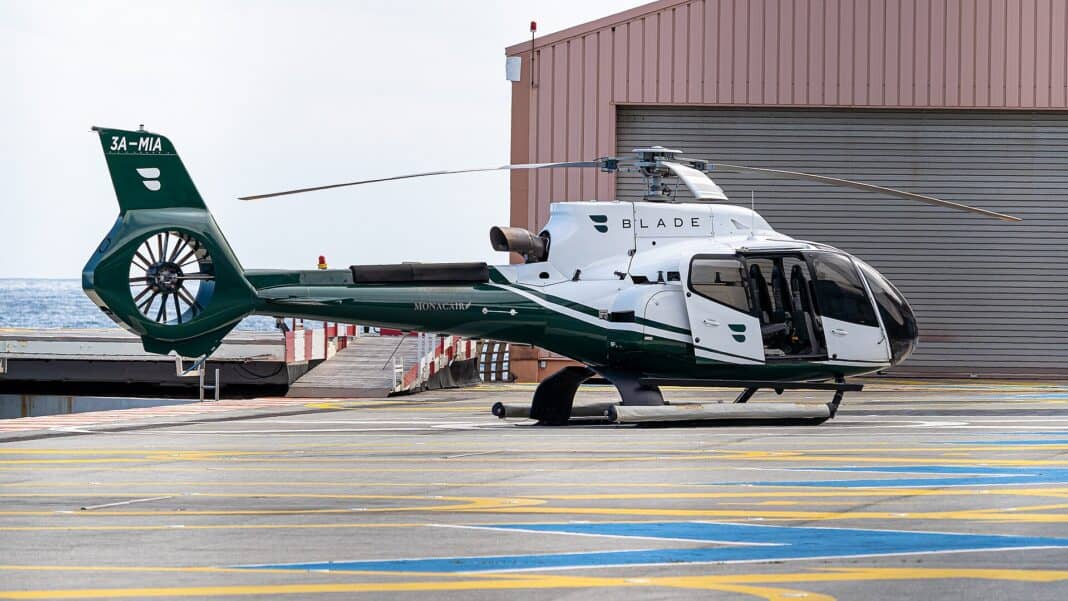 Helicopter Charter Cost: What You’ll Actually Pay in 2026 BLADE-branded Airbus H130 charter helicopter operated by Monacair parked on the Monaco Heliport pad