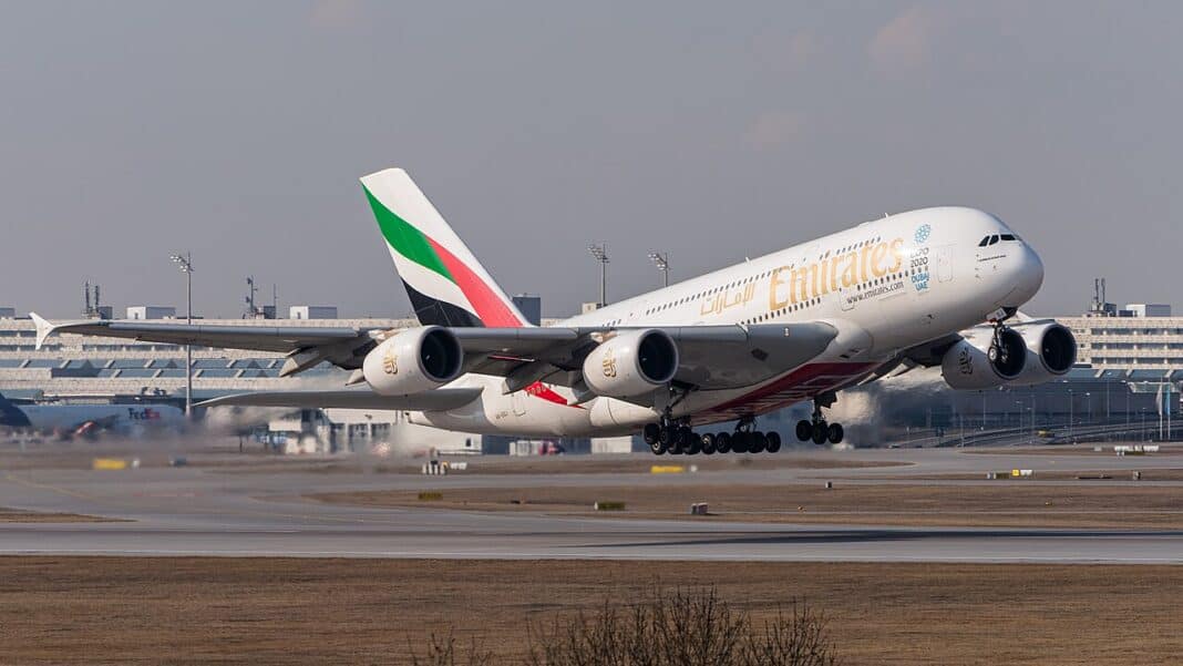 Etihad vs Emirates: Which Gulf Carrier Is Actually Better Emirates Airbus A380 lifting off from a runway with landing gear still extended, gold Emirates titles along the fuselage and the UAE flag livery on the tail