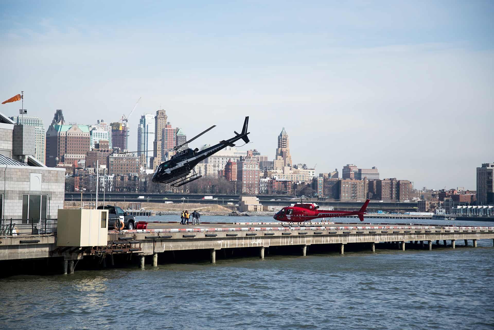 Helicopter lifting off from the Downtown Manhattan Heliport on the East River with the Brooklyn skyline behind