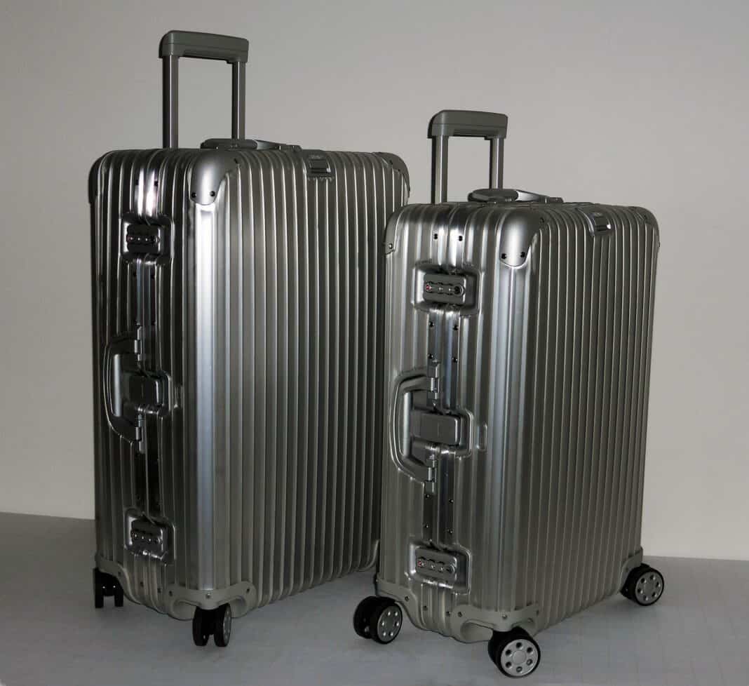 Best Luxury Luggage Brands: The 10 Suitcases That Travel Like You Do Two grooved aluminium Rimowa suitcases with telescoping handles