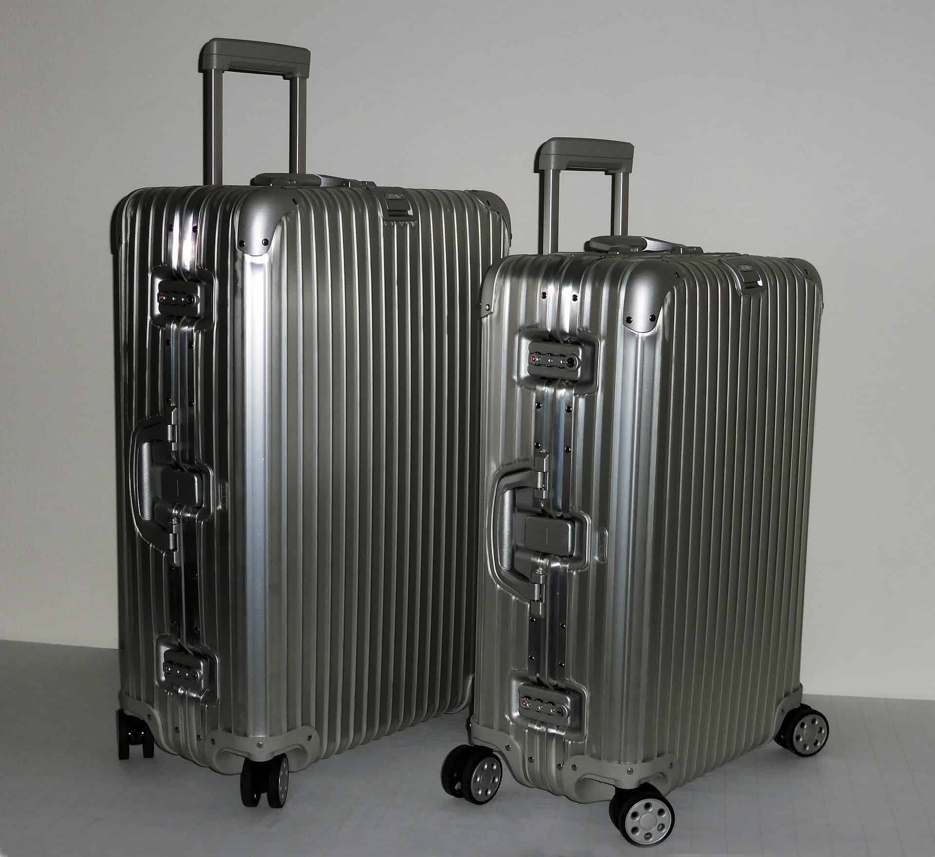 Two grooved aluminium Rimowa suitcases with telescoping handles