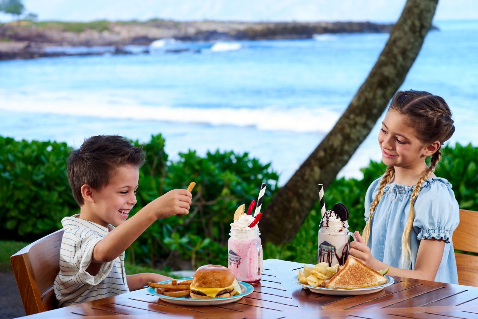 Kids with burgers and milkshakes at Burger Shack, Kapalua